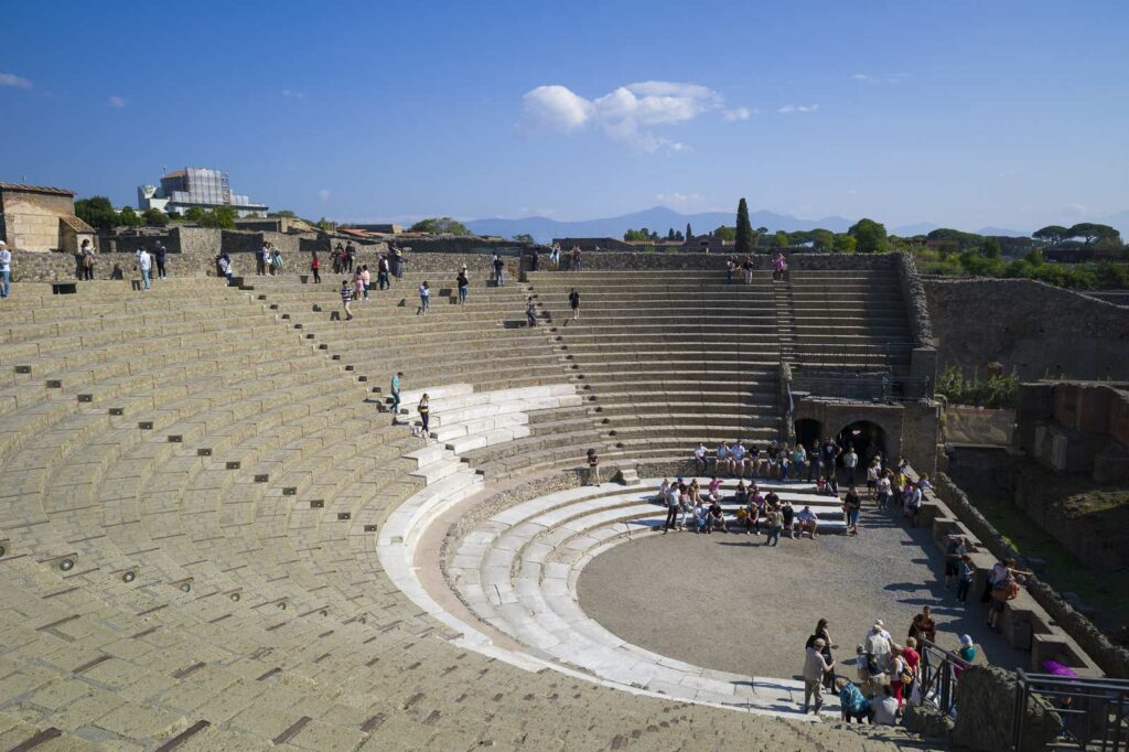 Steps of Pompeii's Large Theatre with visitors exploring