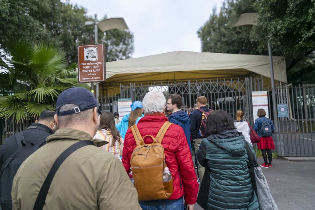 Entrance to Pompeii archaeological site from Amphitheater Gate with tourists in line