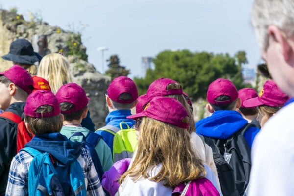Group of schoolchildren in red caps visiting the Pompeii ruins