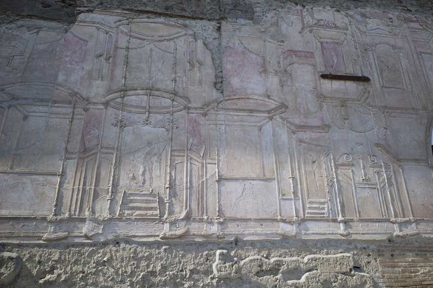 Wall reliefs and faded frescoes of the Stabian Baths of Pompeii