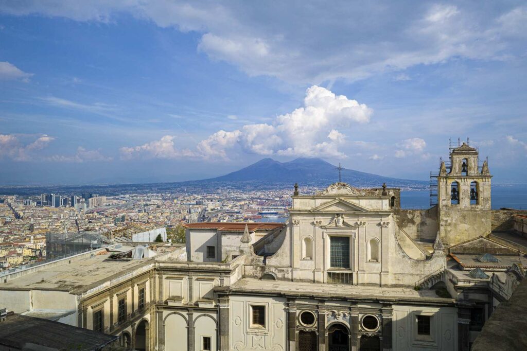 View of the Charterhouse of San Martino with Vesuvius and the Bay of Naples in the background.
