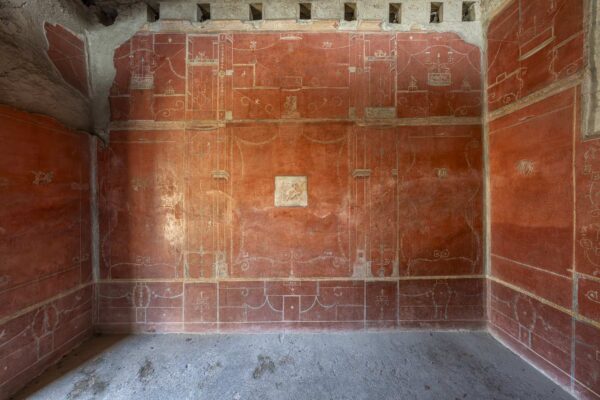 Pompeian third style fresco with red background in the House of the Red Walls in Pompeii
