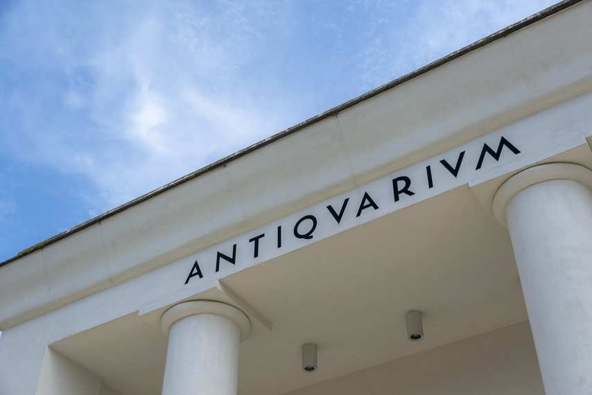 Detail of the Antiquarium inscription on the main facade under a blue sky