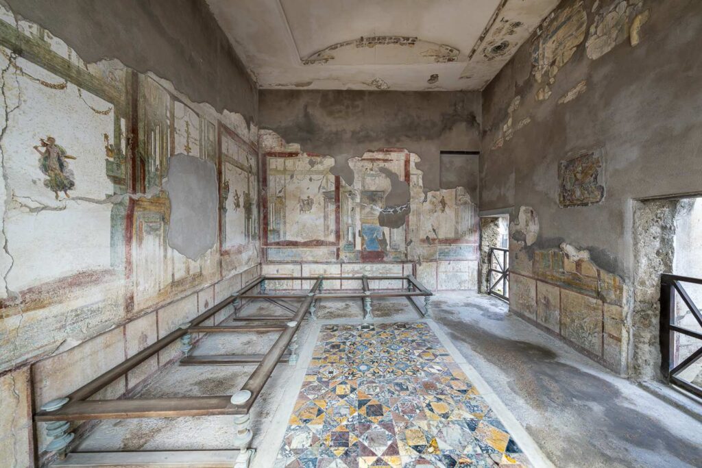 Interior of the House of Ephebus in Pompeii with frescoes and polychrome mosaic floor