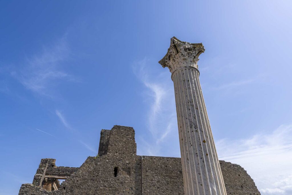 Corinthian column and ruined temple at the Shrine of Venus in Pompeii