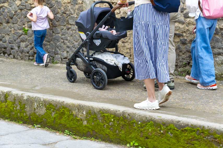 Family with stroller visits Pompeii archaeological site along accessible route