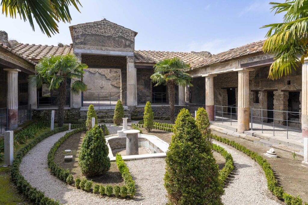 Indoor manicured garden with columns in the House of the Golden Cupids in Pompeii