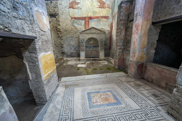 Decorative mosaic fountain with frescoes and mosaic floor in the House of the Wounded Bear in Pompeii