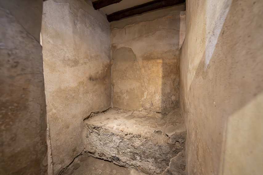 Room with stone bed at the Lupanar of Pompeii
