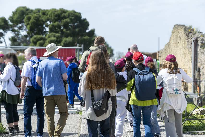 Group of students and tourists during a guided tour of the Pompeii Archaeological Park