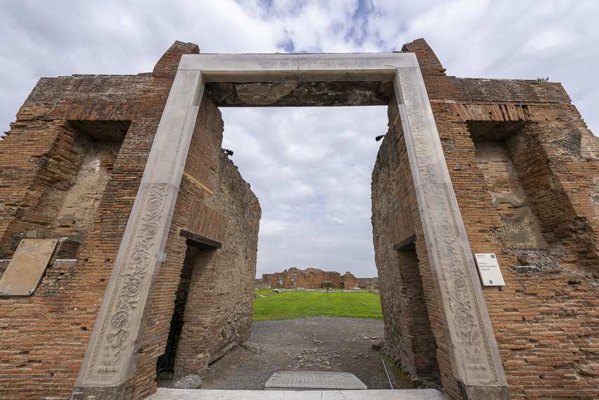 Entrance of the Portico of Concordia Augusta in Pompeii with modern arch and ancient ruins