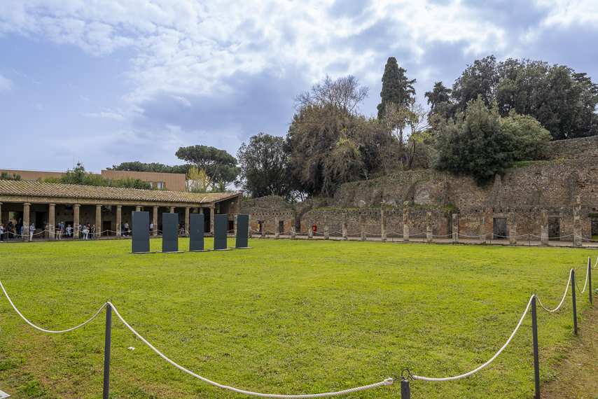 View of the Quadriporticus of the Theatres in Pompeii with porticoes and green area