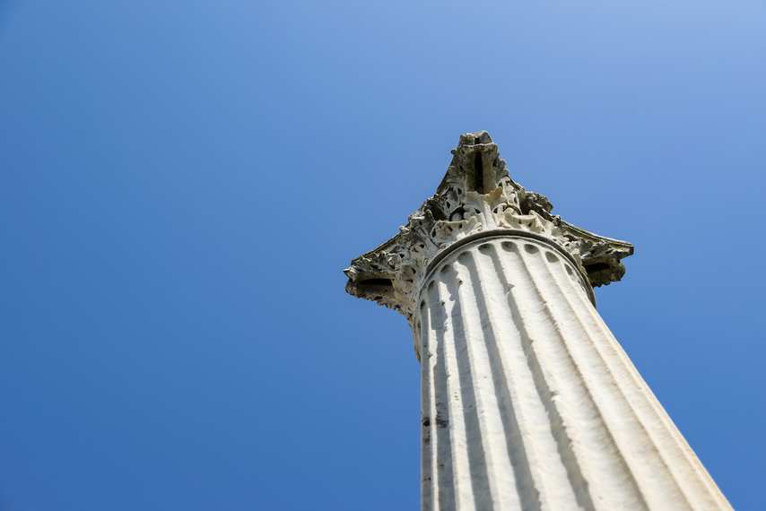 Corinthian column of the Temple of Venus in Pompeii against the blue sky