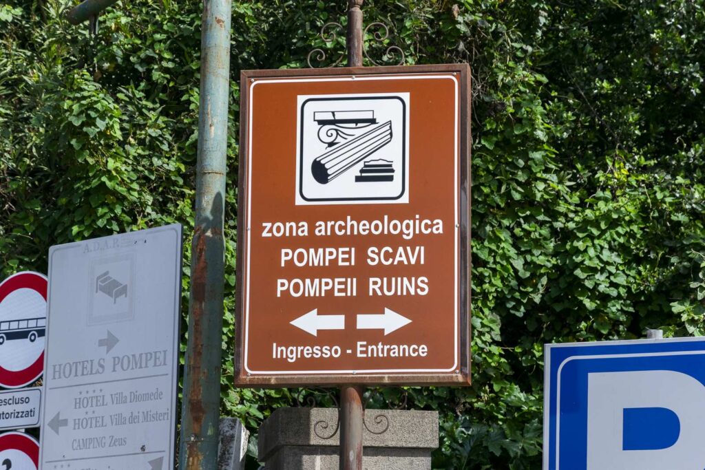 Signage for entrance to Pompeii excavations and indication of parking 100 meters away