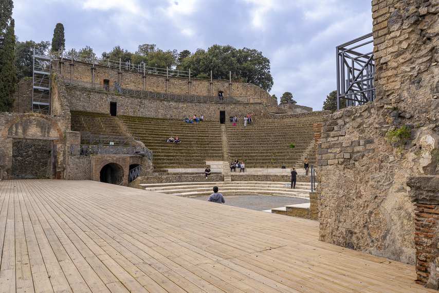 The Large Theatre of Pompeii as seen from the stage with bleachers and visitors