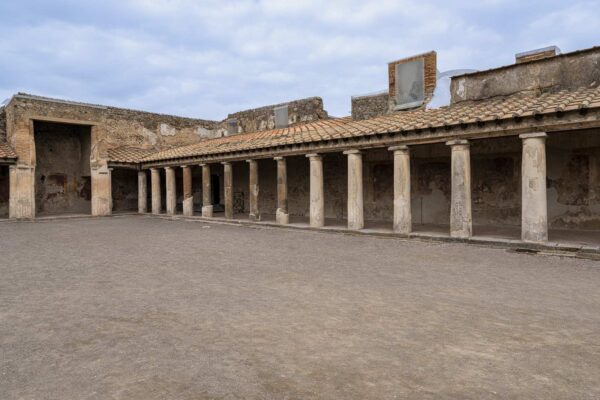 View of the interior colonnade of the Stabian Baths in Pompeii with cloudy skies